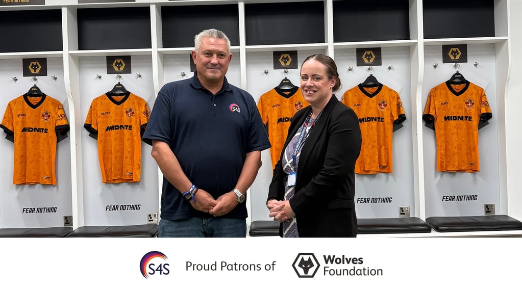 Services 4 Schools management team in the Wolverhampton Wanderers dressing room at Molineux Stadium, marking the launch of the club's Wolves Foundation Pack Patron partnership for the 2026/27 season.